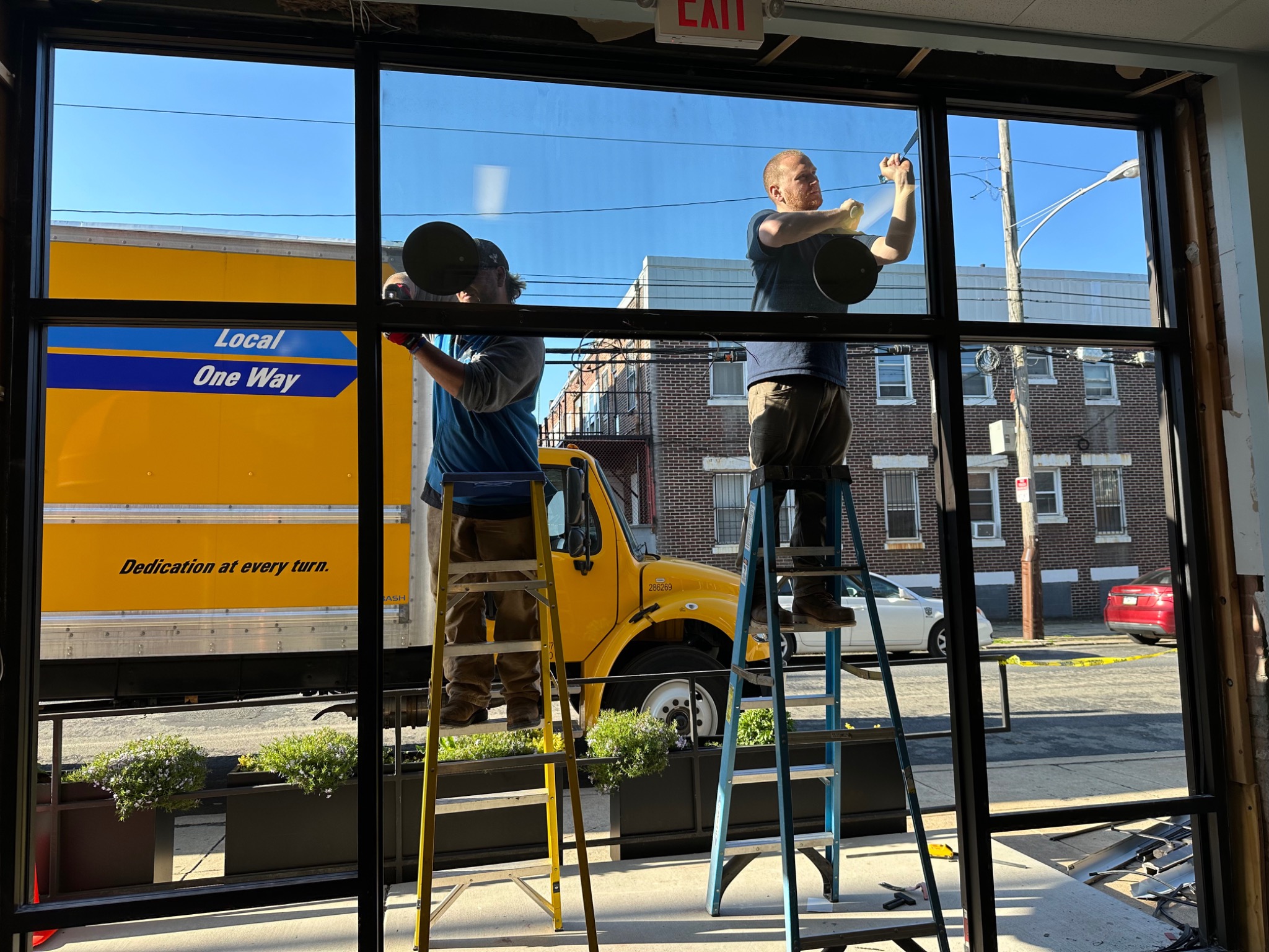 Installation team fitting protective glazing at a separate Philadelphia school location